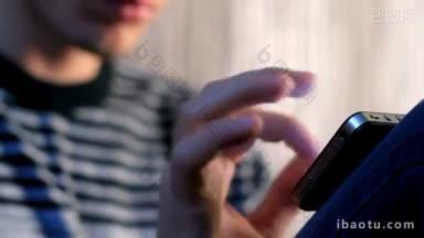 年轻的成年男子使用和玩触摸屏手机